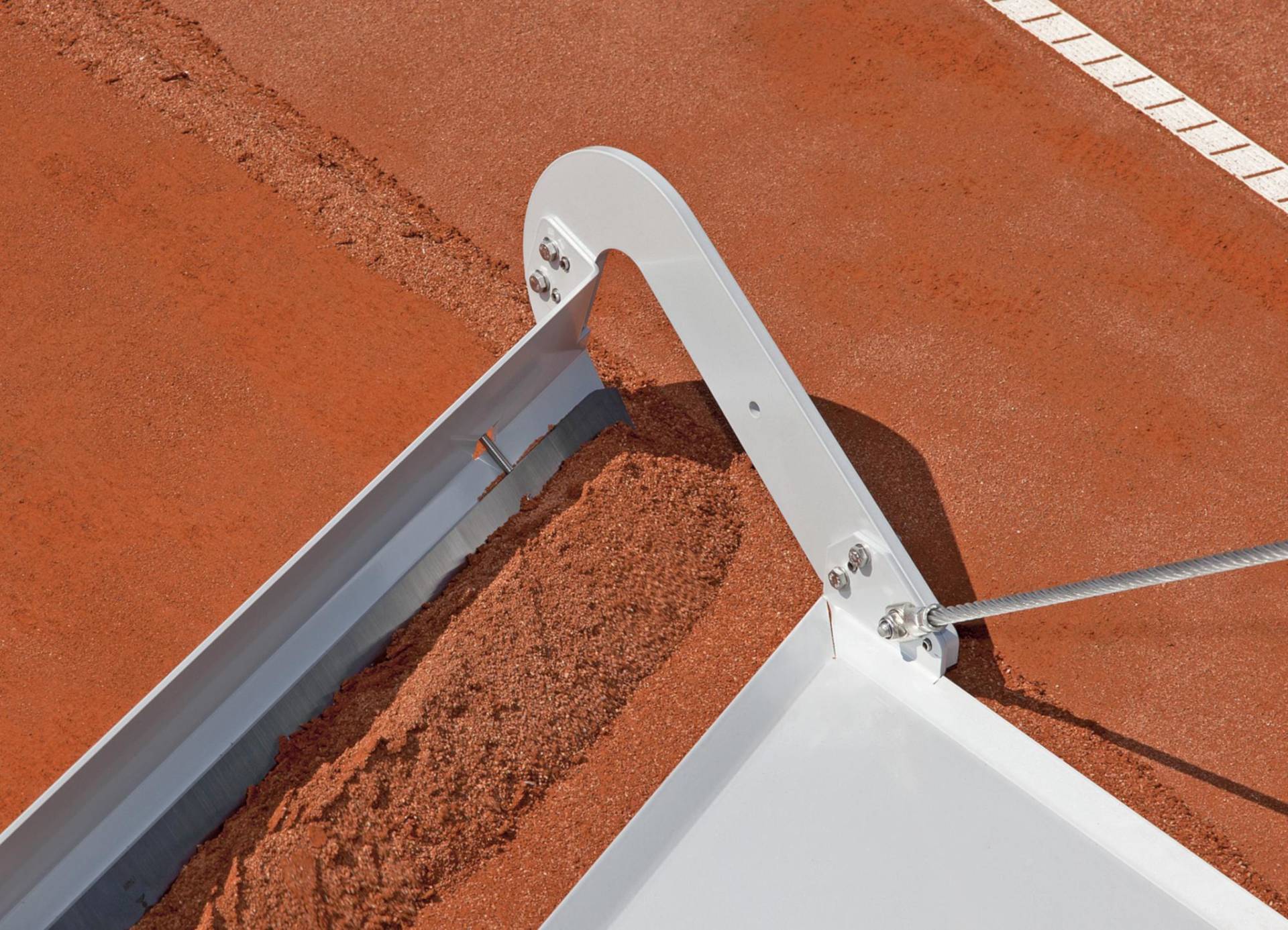 <i class='fas fa-angle-double-right'></i> Das Altsandmesser TM2 im Einsatz. Die stählerne Metallplatte schiebt sich über den Altsand. Das Hauptmesser, 2mm tiefer liegend fixiert, „schneidet“ bzw. schabt exakt die gewünschte Schicht des Altsandes ab. Das gefühlvoll schräg geführte TM2 schiebt den Altsand nach außen.